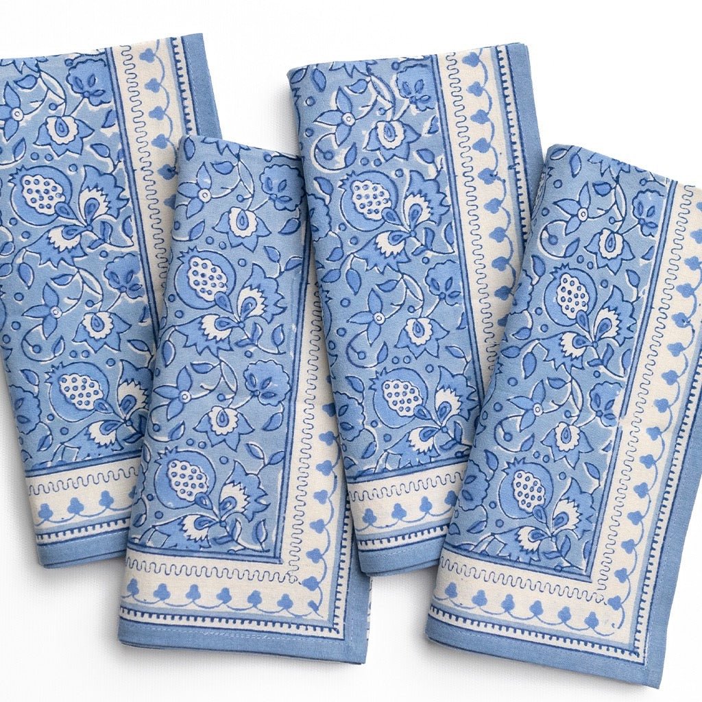 Set of blue and white patterned napkins on a white background