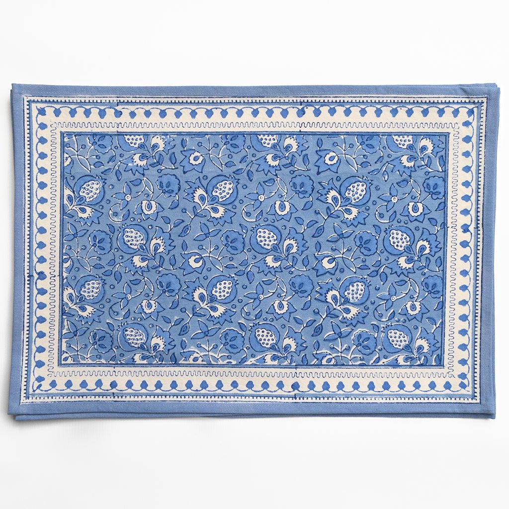 Blue and white patterned placemats on a white background