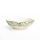 White bowl with green decorative pattern on a white background