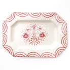 Decorative platter with red floral and pomegranate design on a white background
