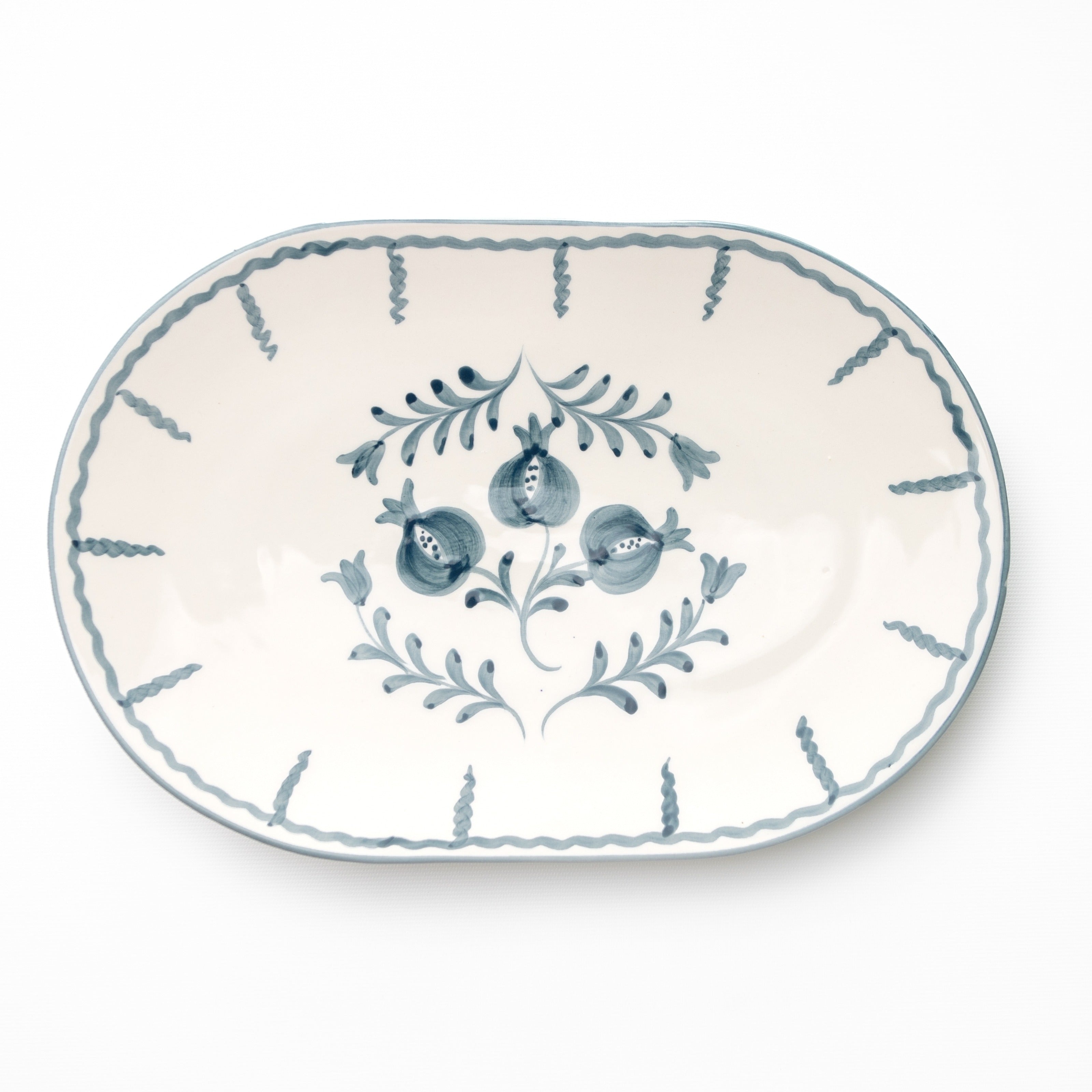 Decorative platter with blue floral and pomegranate design on a white background