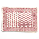 Stack of red and white patterned tablecloths on a white background