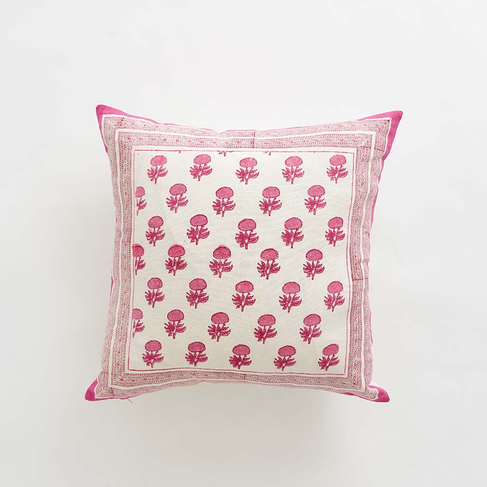 Decorative pillow with pink floral pattern on a white background