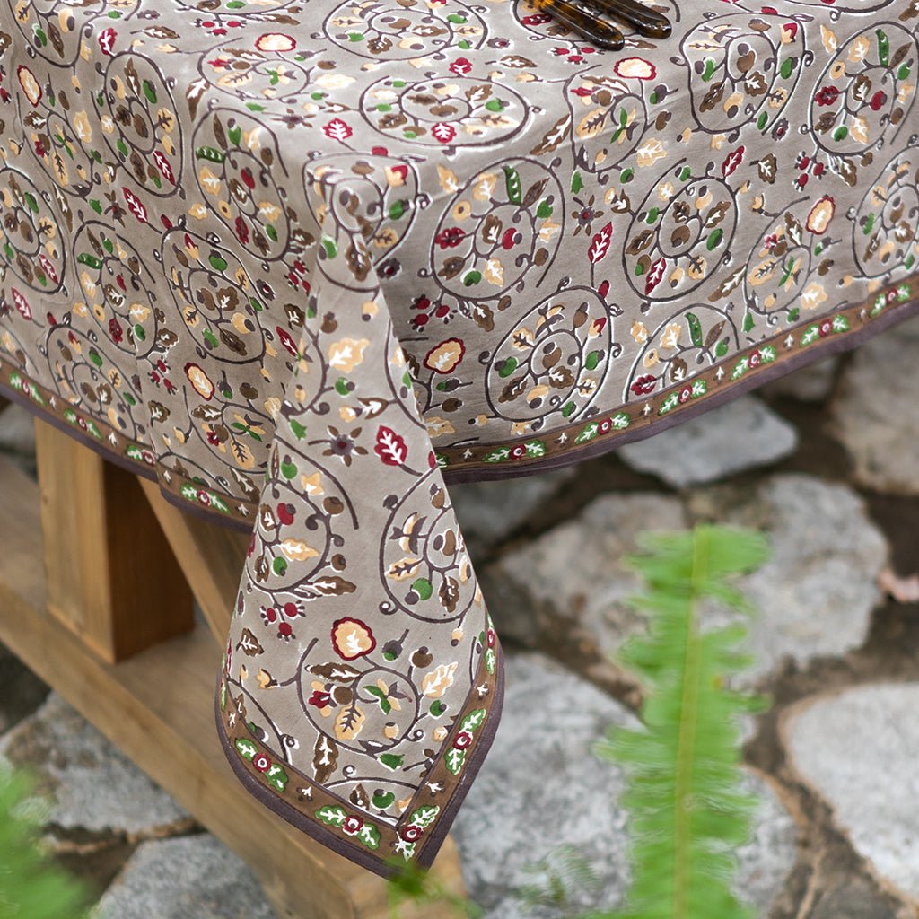 Decorative tablecloth with intricate paisley pattern on a stone surface