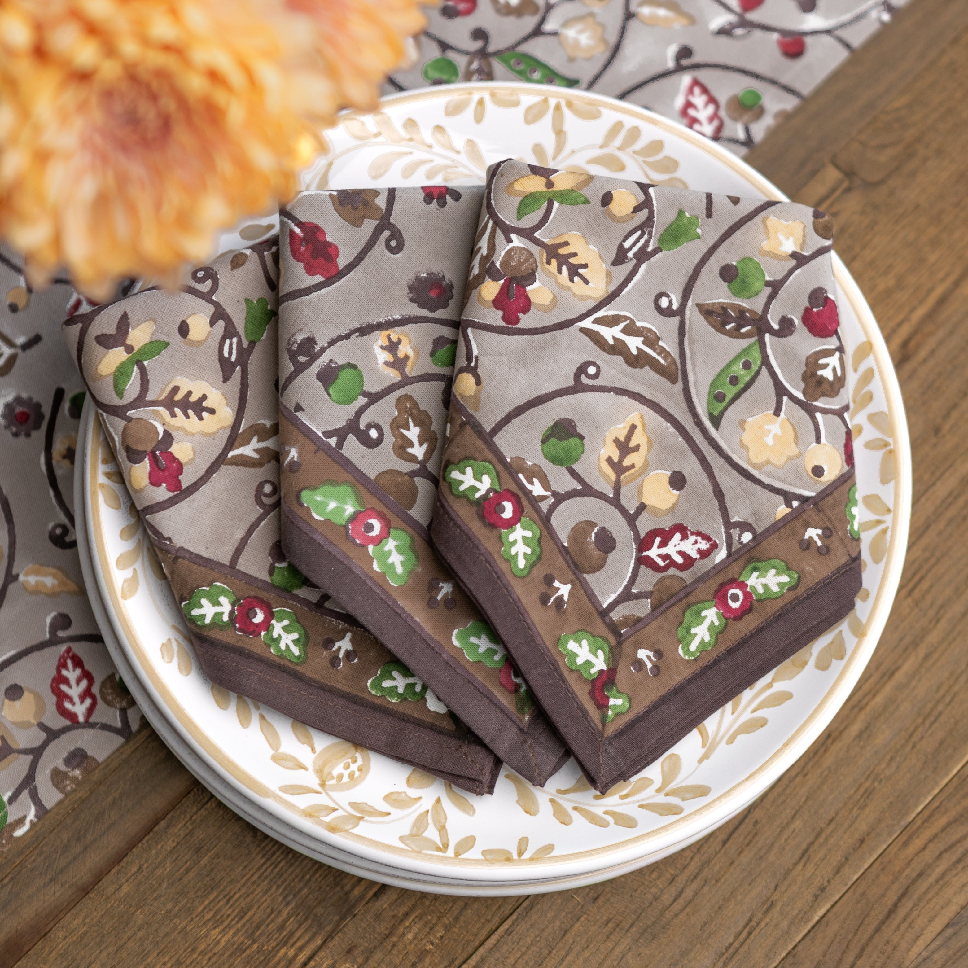 Decorative napkins with leaf pattern on a plate with floral design
