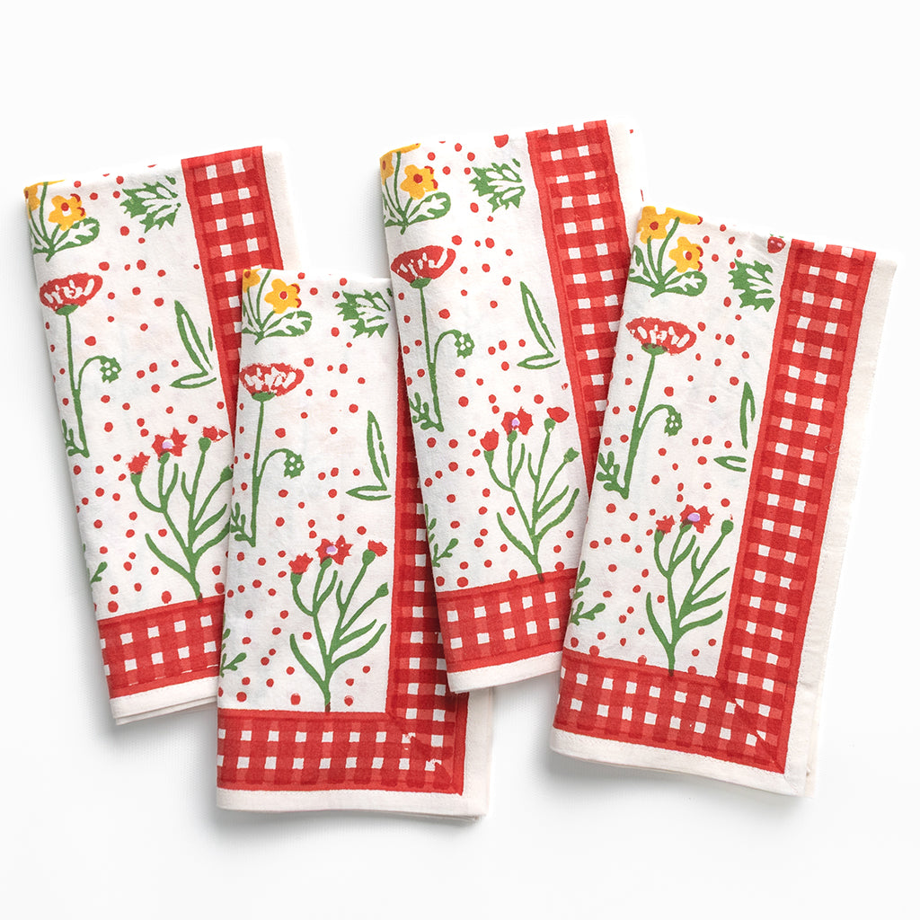 Set of floral and checkered patterned napkins on a white background