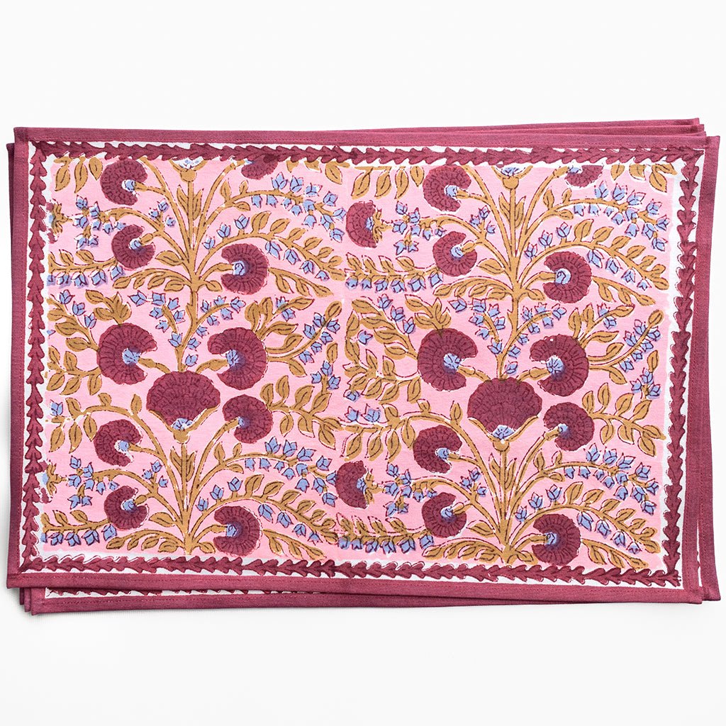 Decorative pink fabric with floral pattern on a white background