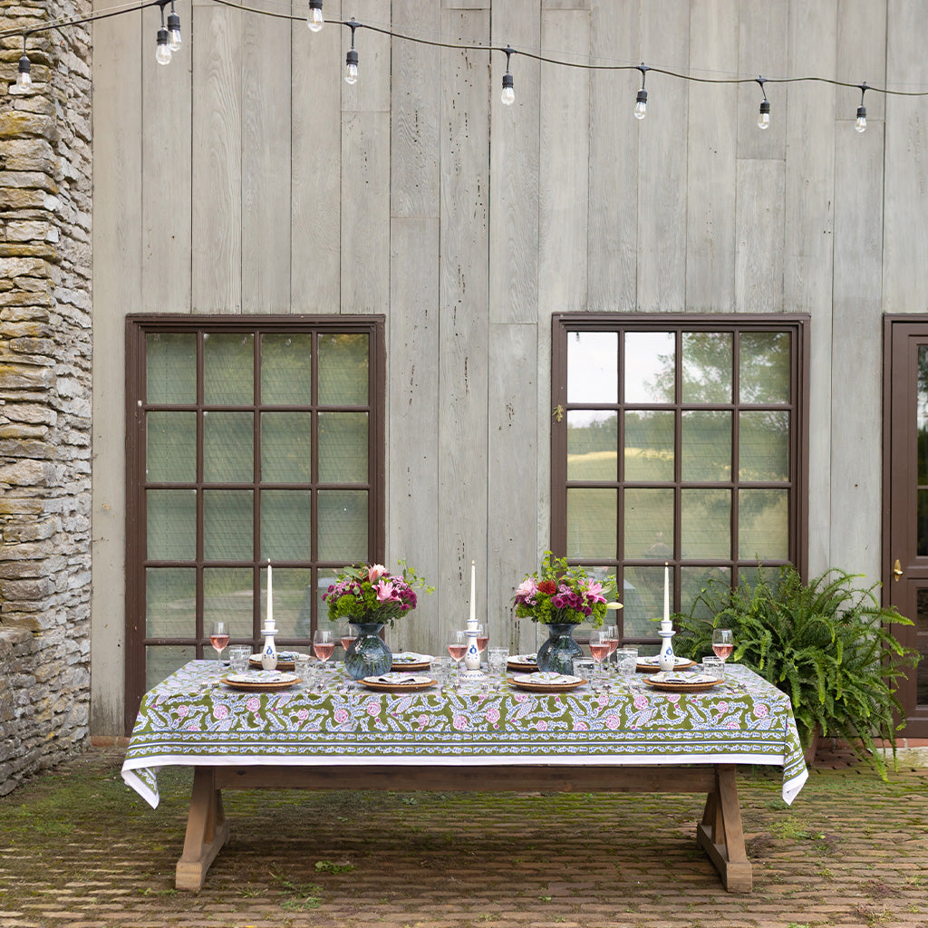 Table set outdoors under string lights.