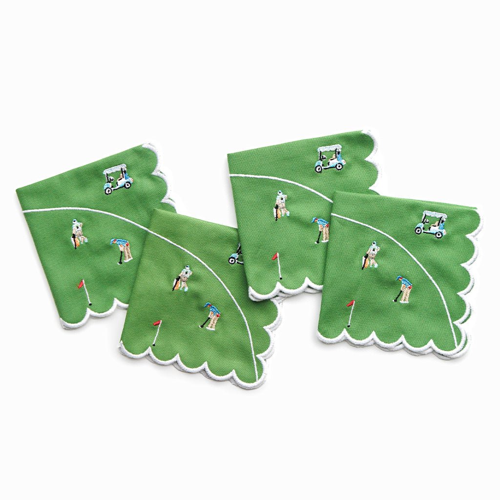 Green napkins with golf-themed designs on a white background