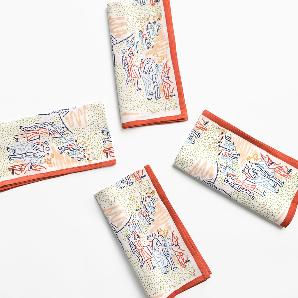 Four folded napkins with a colorful pattern on a white background