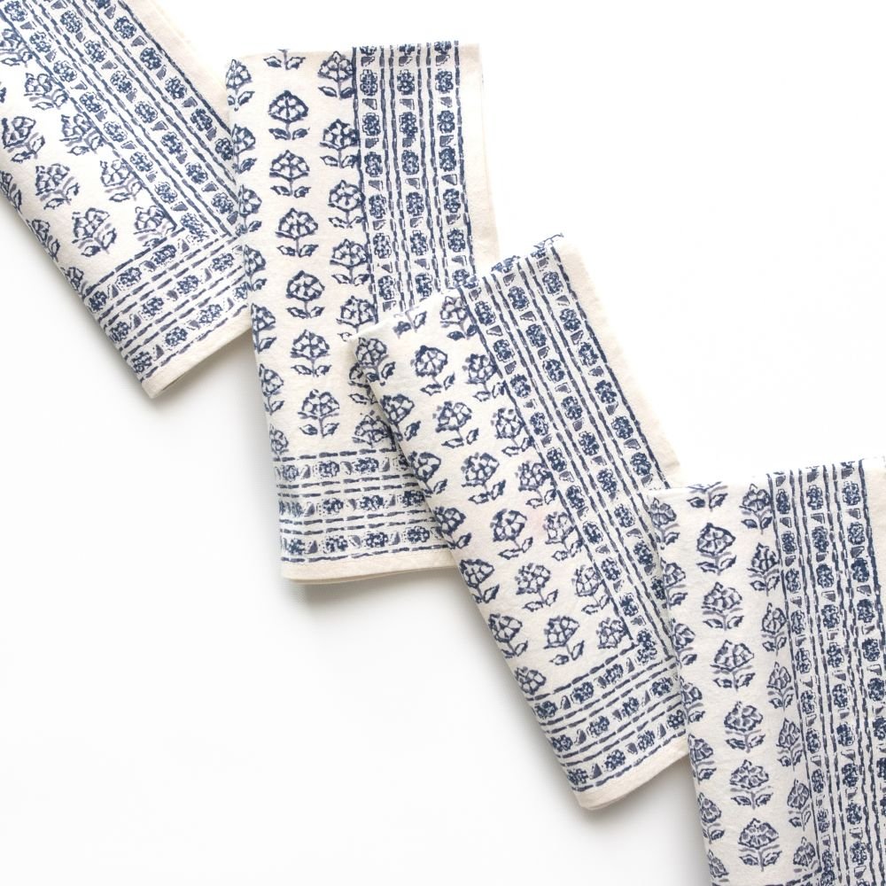 Set of white napkins with blue floral patterns on a white background