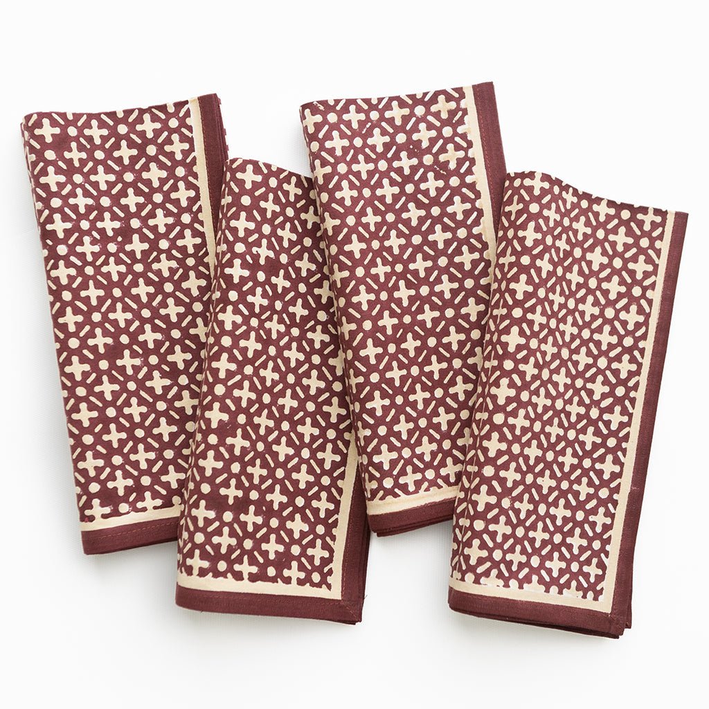 Four patterned towels with a geometric design on a white background