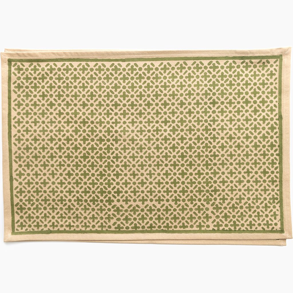 Patterned placemat with green and beige design on a white background