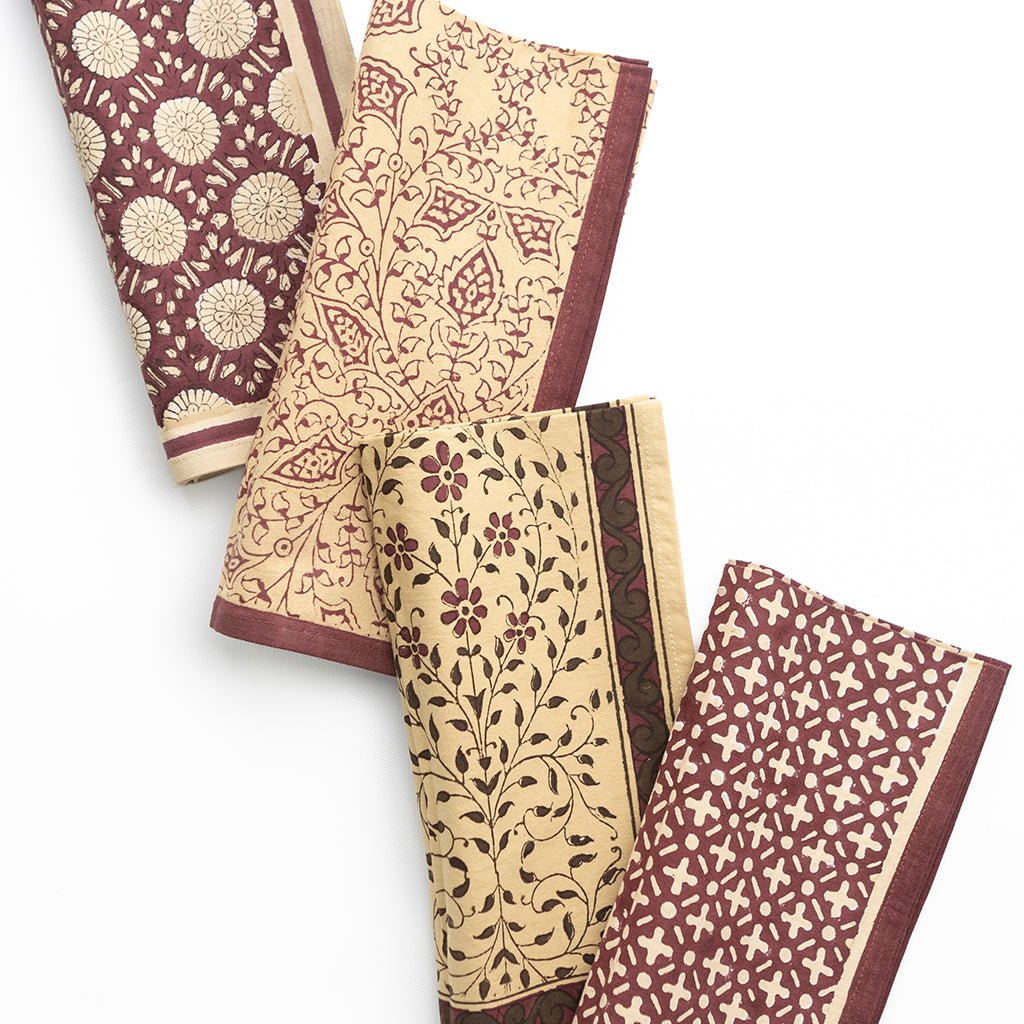 Set of four patterned napkins on a white background