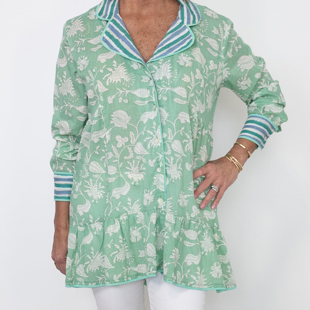 Green floral patterned shirt with striped collar on a white background