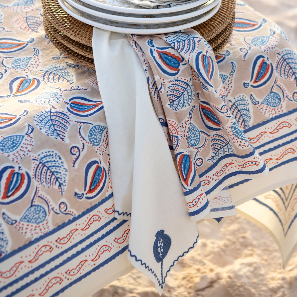 Patterned tablecloth with blue and red designs on a table setting.