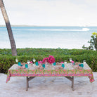 Green & pink pinecone botanical block printed tablecloth with a scenic ocean background