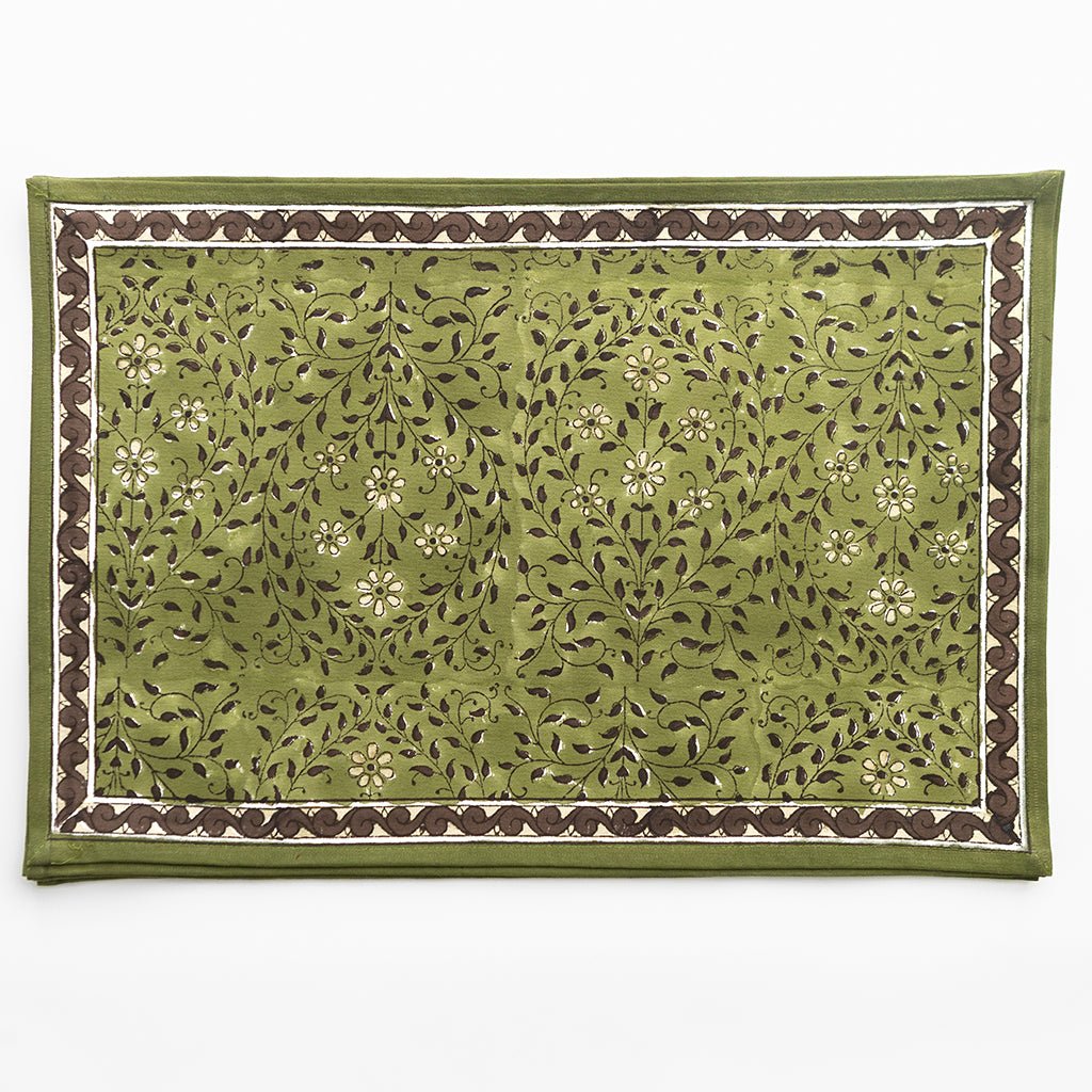 Green fabric with floral pattern and brown border on a white background