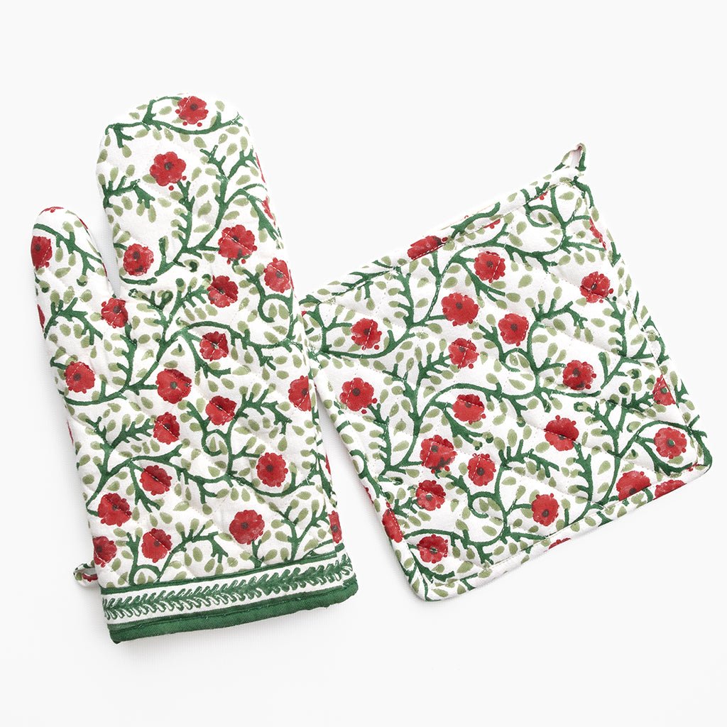 Floral patterned oven mitt and pot holder on a white background