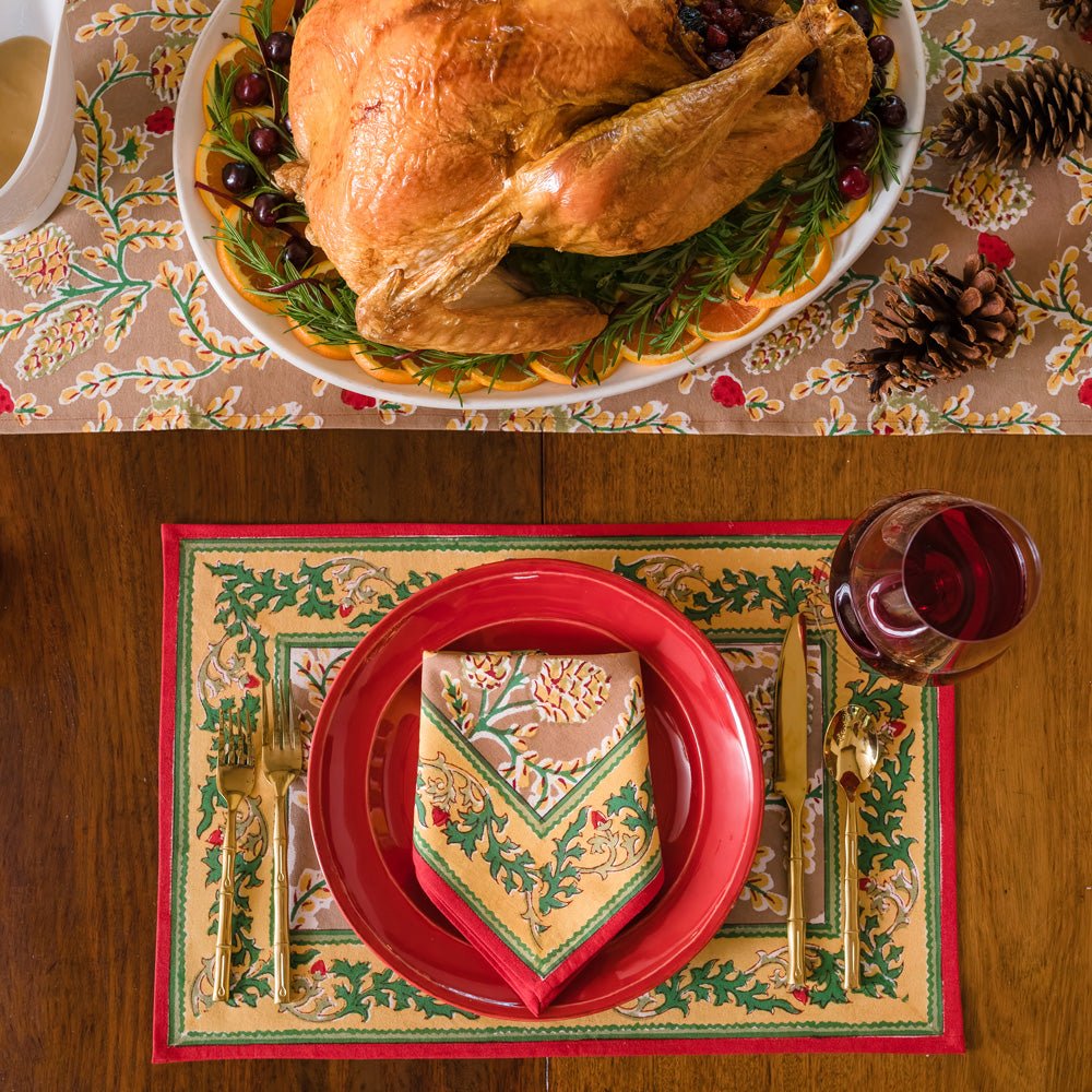 A table setting with pinecone motif table linens