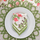 Folded napkin on white plate.