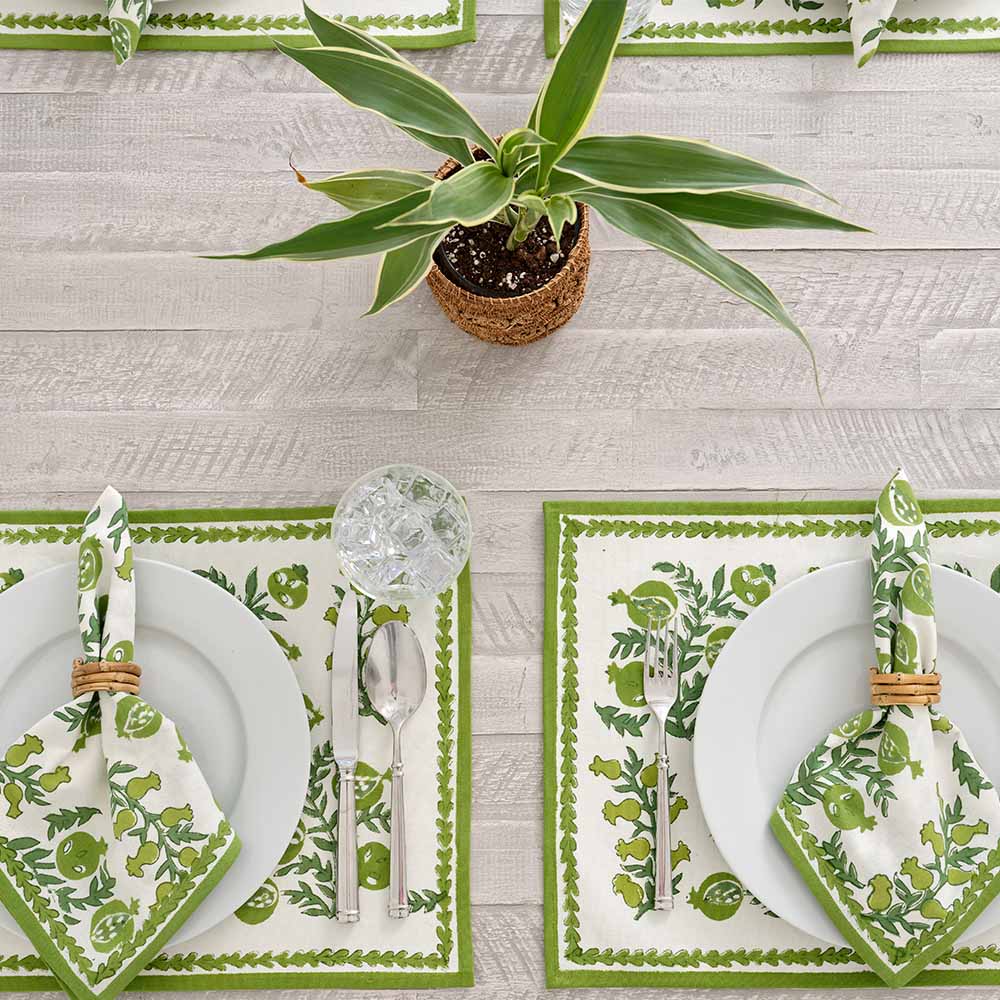 Placemats complimented with matching napkins and green plant.
