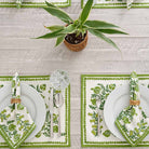 Placemats complimented with matching napkins and green plant.