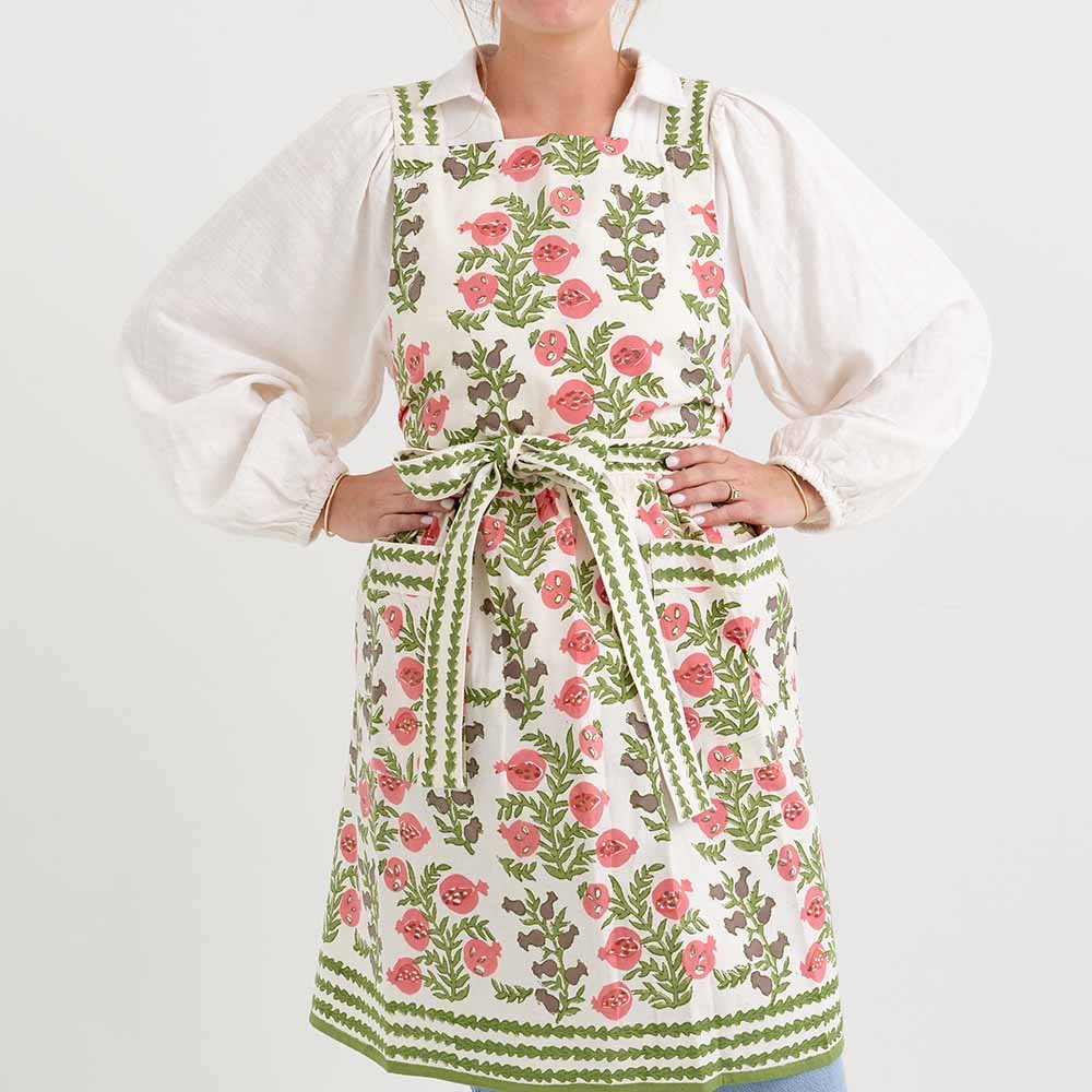 Pom Bells Fern & Poppy Apron with ties behind the neck and at the waist.