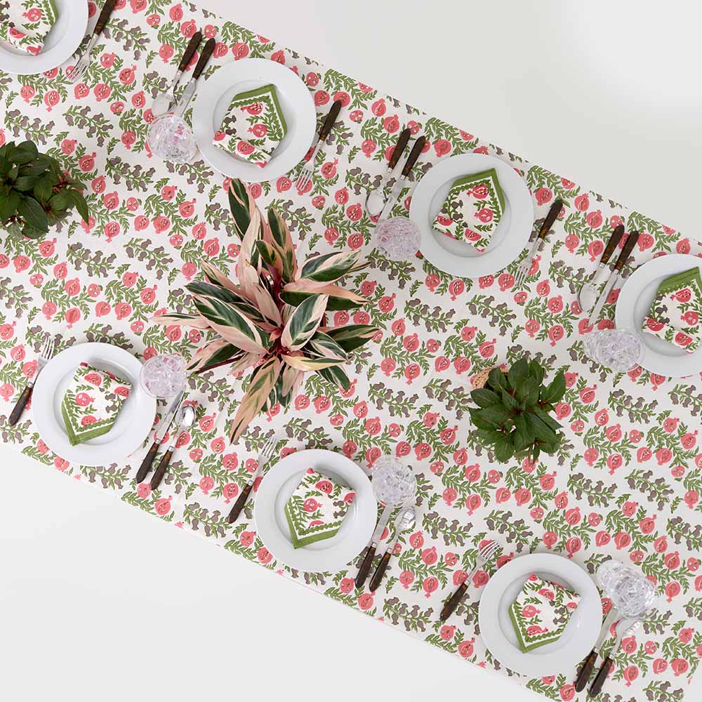 Overhead view of Pom Bells Fern & Poppy tablecloth. 