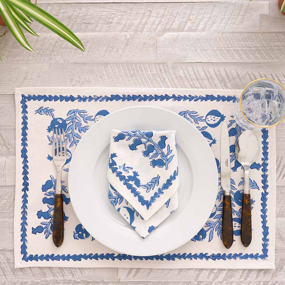 Folded napkin on white plate paired with matching placemat.