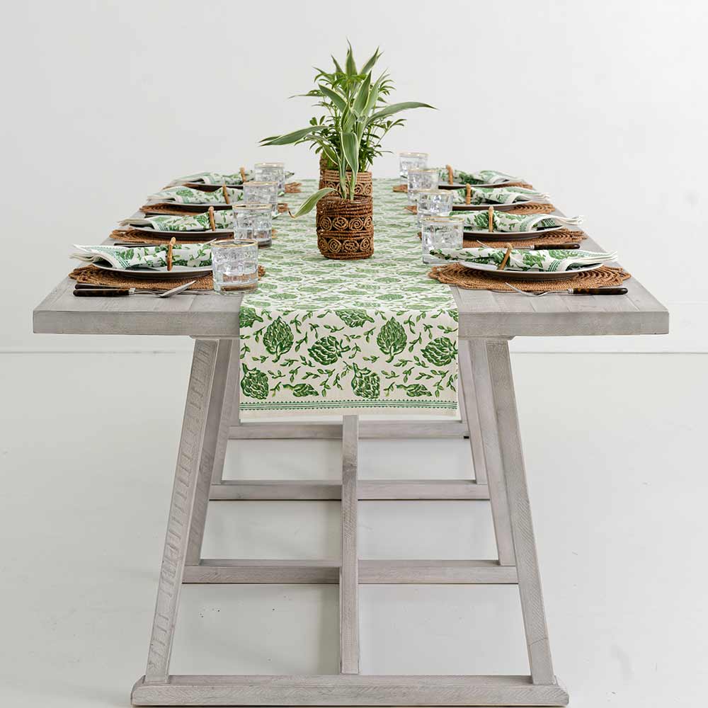 Table runner decorating middle of dinner table.