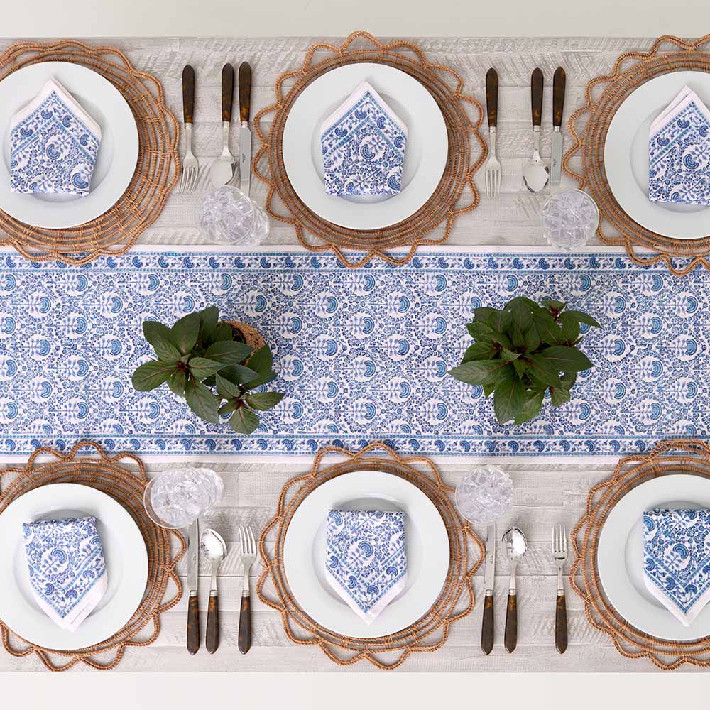 Table runner paired with matching napkins decorating dinner table.