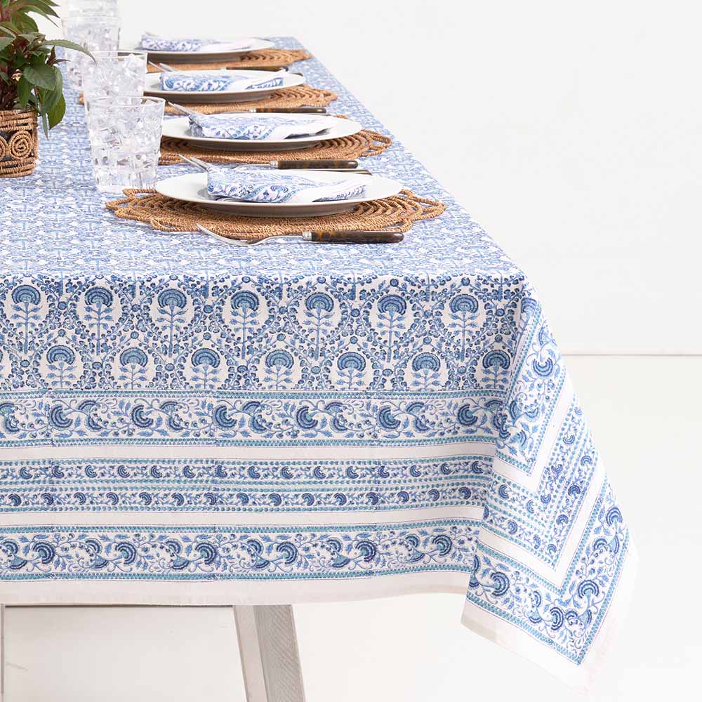 Warm hues of mixed blues paired with the intricate white details make this tablecloth stand out.
