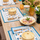 Dinner table with matching placemats and napkins.