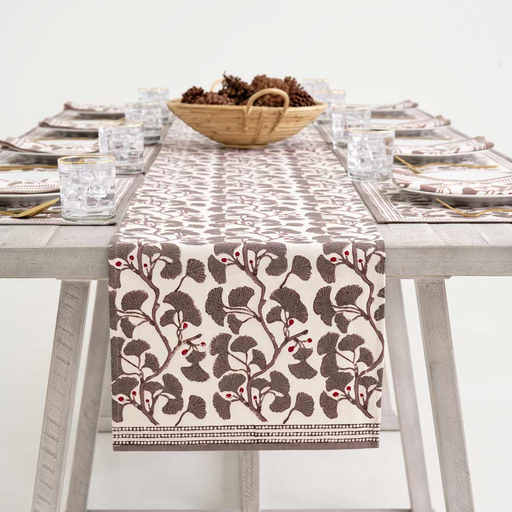 Ginkgo Taupe table runner draped over side of table.