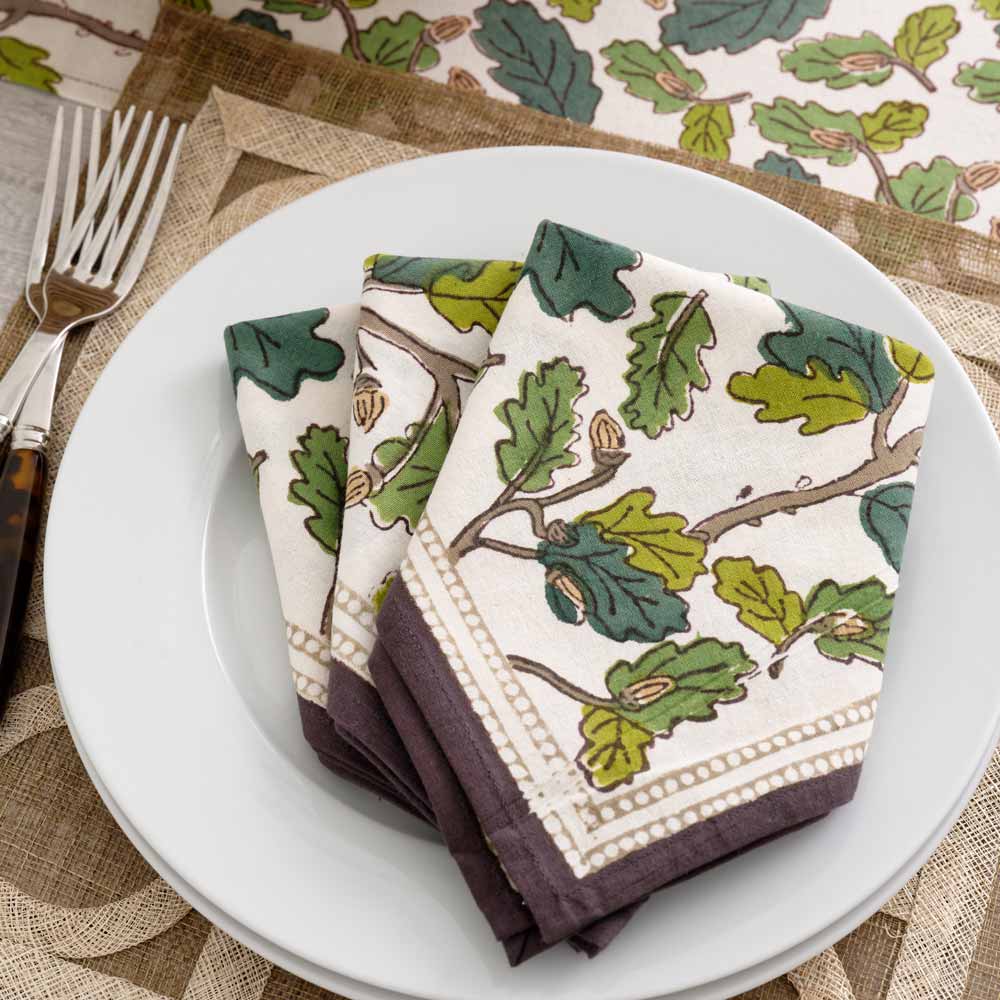 Napkins folded on white plate.