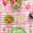Rose Bamboo Tablecloth with pink flowers and green dishes.