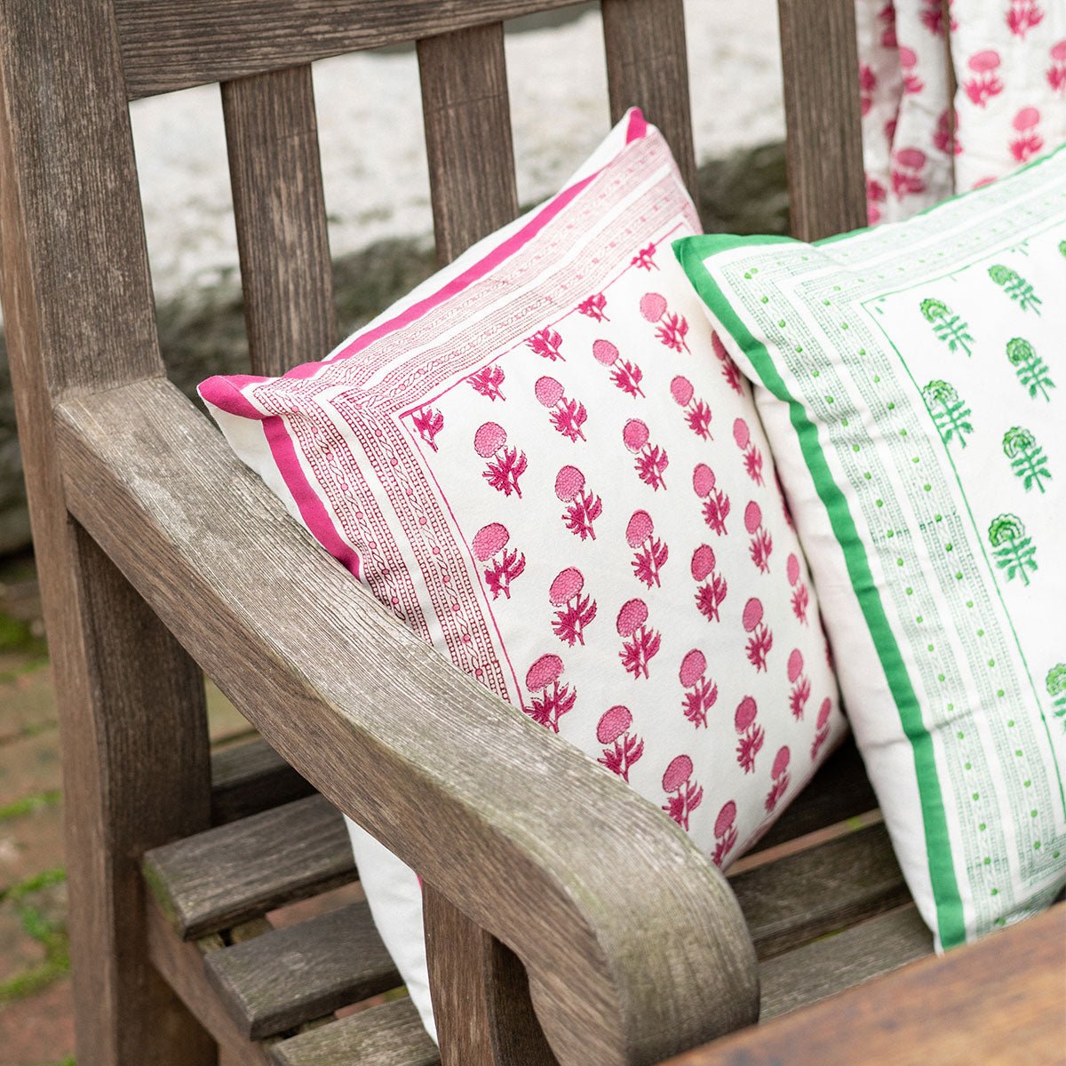 Pink and white print pillow cover paired with green and white print pillow cover.