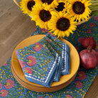 Cactus Flower Midnight Dark Blue & Magenta Floral  napkins on yellow plate with matching table runner and sunflowers