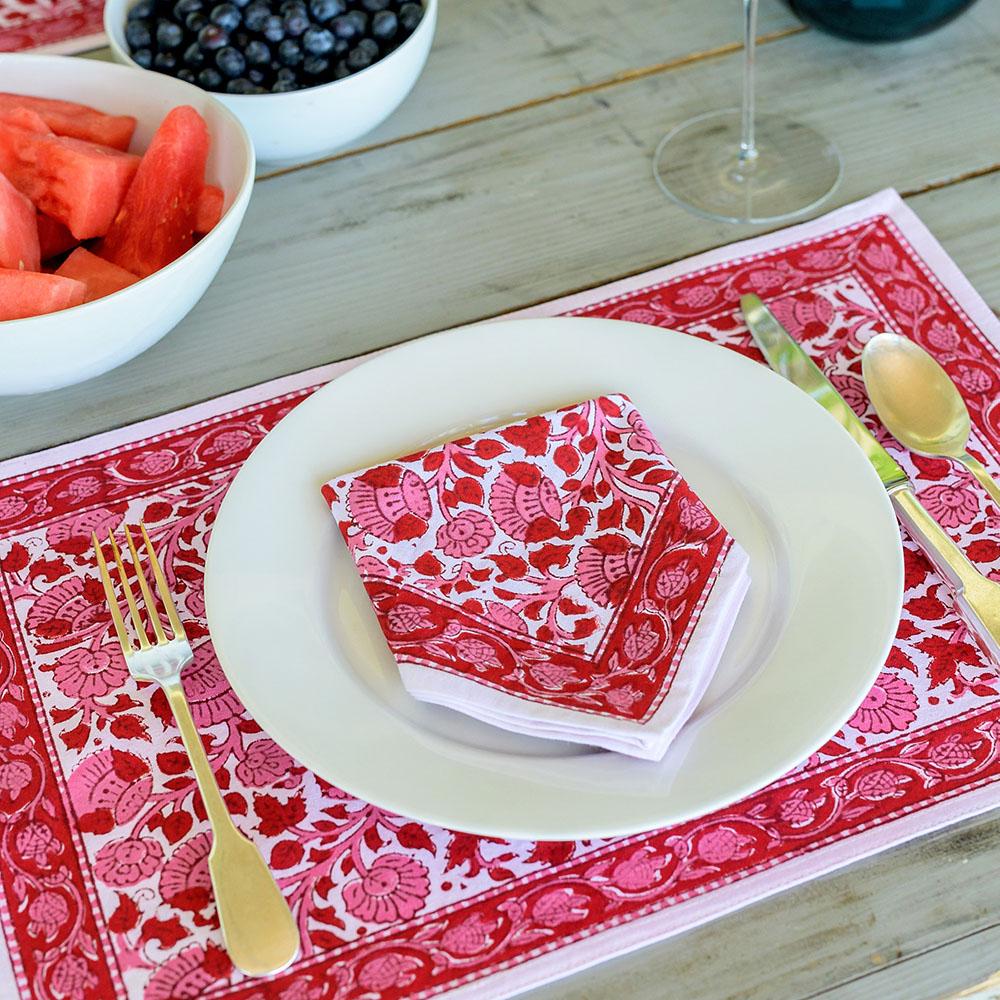 The napkin is paired with the matching placemat and accented with gold silverware.