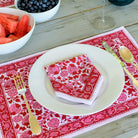 The napkin is paired with the matching placemat and accented with gold silverware.