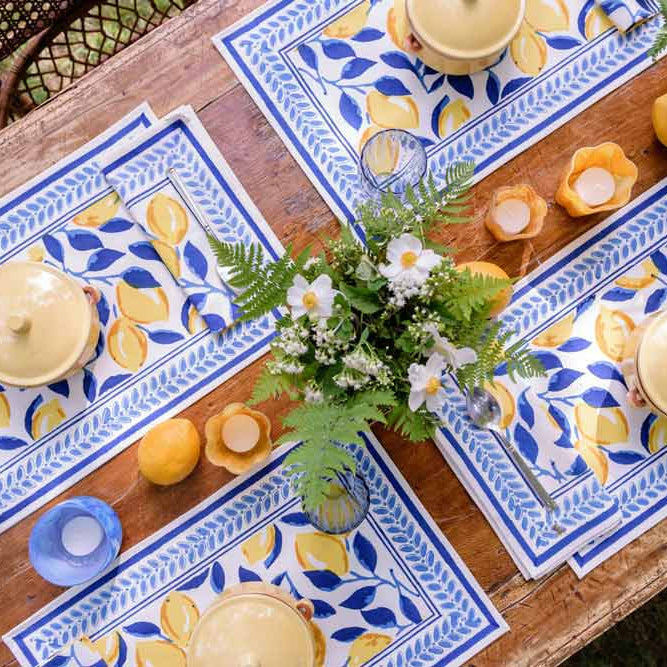Table with lemon and navy placemats.