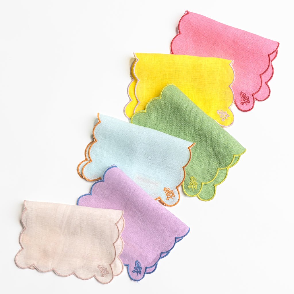 Set of colorful baby bibs with scalloped edges on a white background