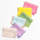 Set of colorful baby bibs with scalloped edges on a white background
