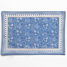 Blue and white patterned placemats on a white background