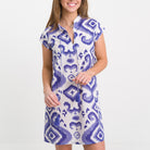 Woman wearing a blue and white patterned dress on a white background