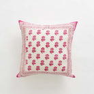 Decorative pillow with pink floral pattern on a white background