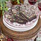 Decorative plates with floral patterns on a woven placemat.