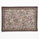 Decorative rug with floral and leaf pattern on a white background