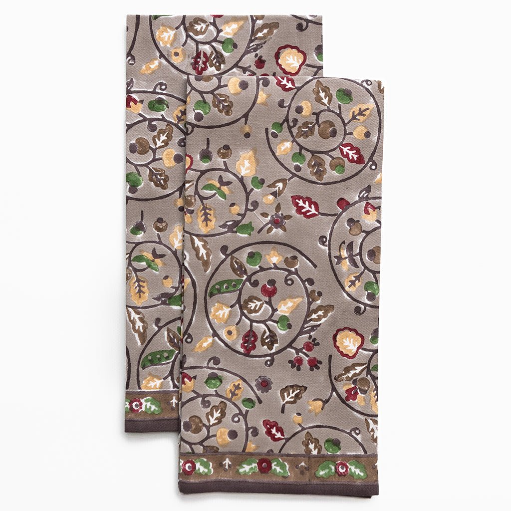 Decorative kitchen towels with floral and leaf pattern on a white background